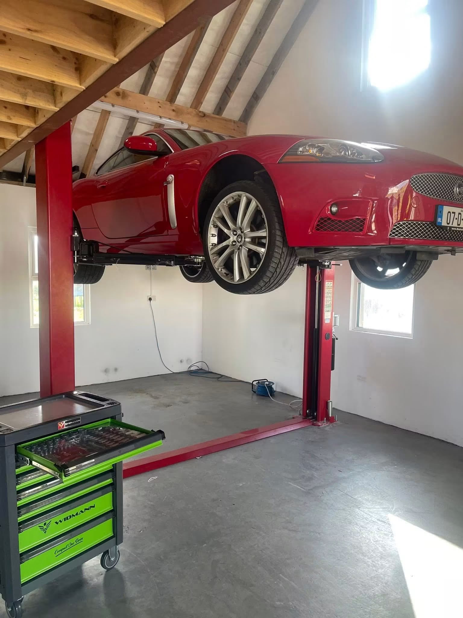 Pacini PC4000F two post car lift with Jaguar XKR raised